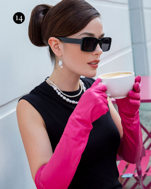 Woman wearing long leather gloves in sorbet drinking a coffee