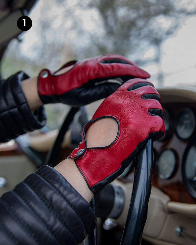 Woman wearing touchscreen leather gloves in berry/black