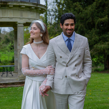 Husband and wife wearing wedding gloves in the park