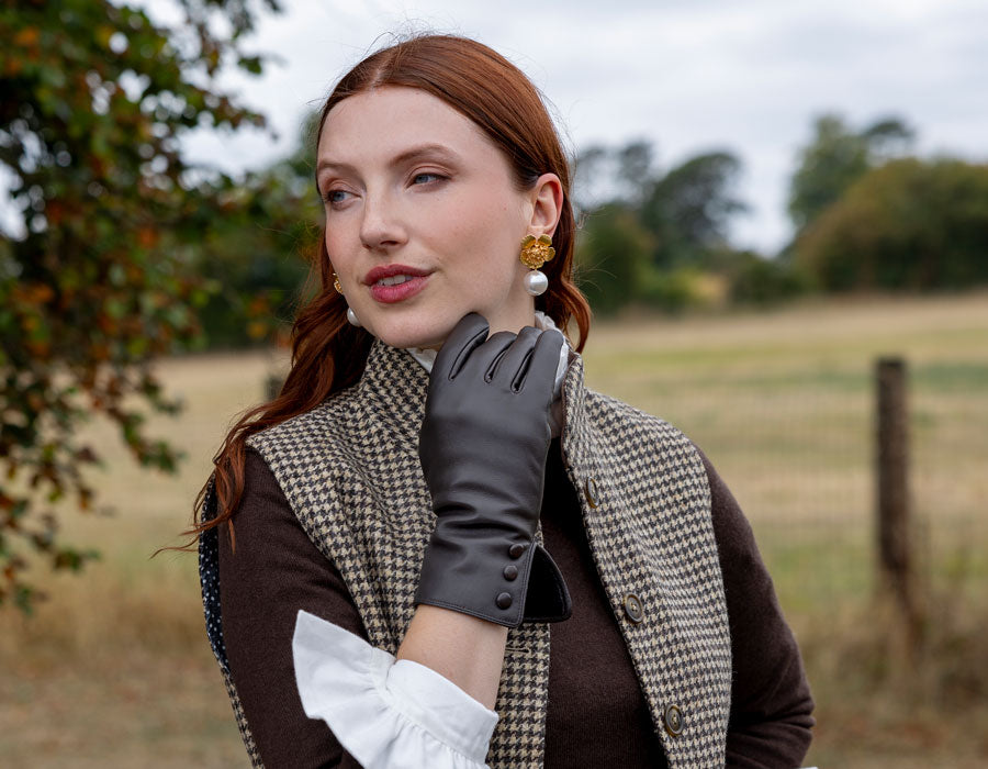 woman wearing leather gloves in mocca walking around the countryside