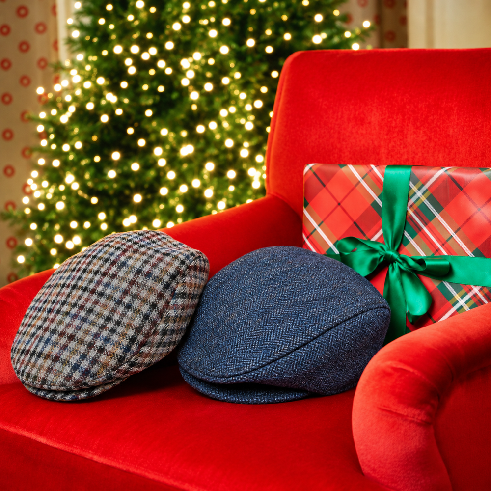 Two men's tweed flat caps on a red armchair in front of a Christmas tree
