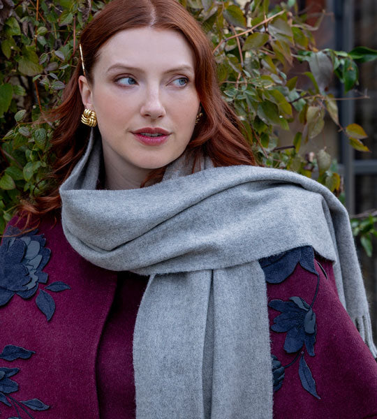 Woman wearing cashmere scarf in grey outdoors