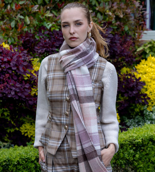 Woman wearing a cashmere scarf in pink outdoors