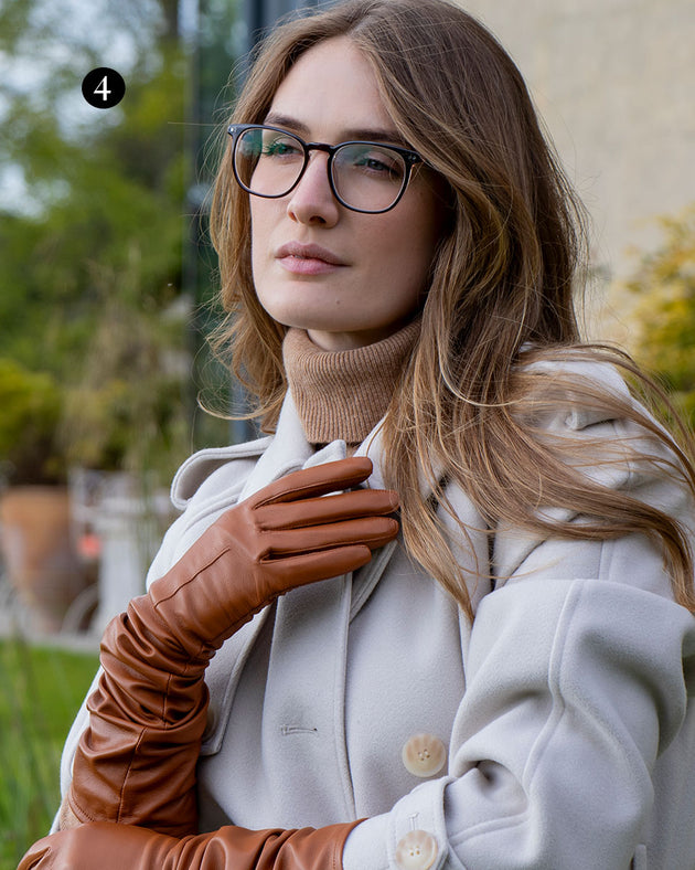 Woman wearing cognac long above-elbow lined leather gloves