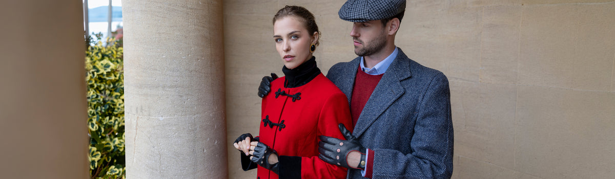 Man and woman wearing leather driving gloves in black outdoors