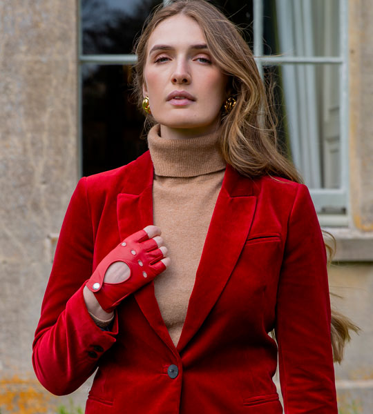 Woman wearing fingerless berry driving gloves outdoors