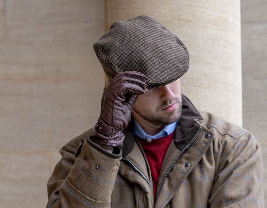 Men's wearing a tweed flat cap outdoors