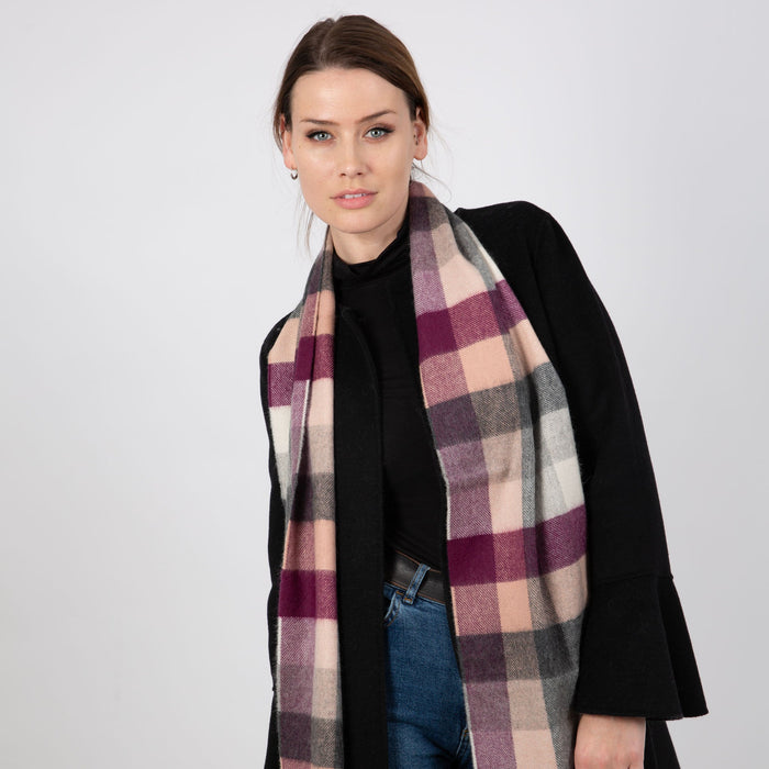 Woman wearing a Heritage plaid check cashmere scarf in casiss