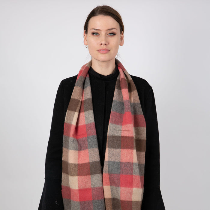 Woman wearing a Heritage plaid check cashmere scarf in chilli