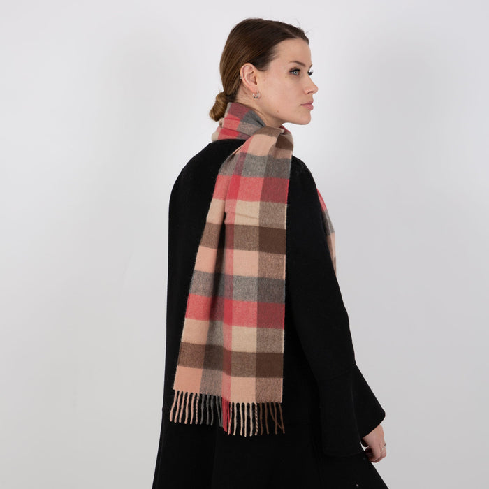 Woman wearing a Heritage plaid check cashmere scarf in chilli