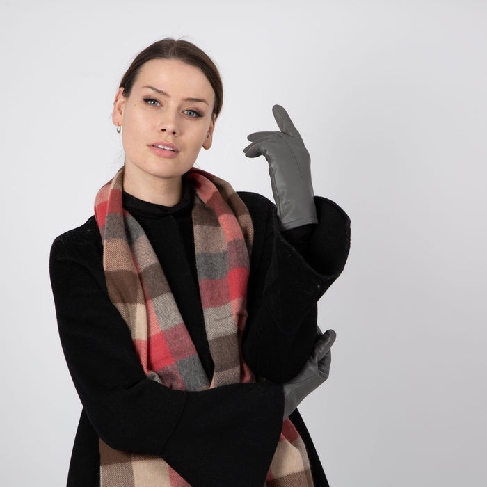 Woman wearing a Heritage plaid check cashmere scarf in chilli