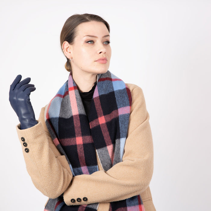 Woman wearing a Heritage plaid check cashmere scarf in frost