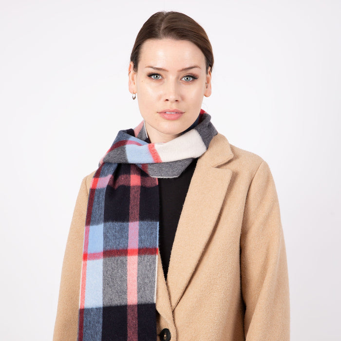 Woman wearing a Heritage plaid check cashmere scarf in frost