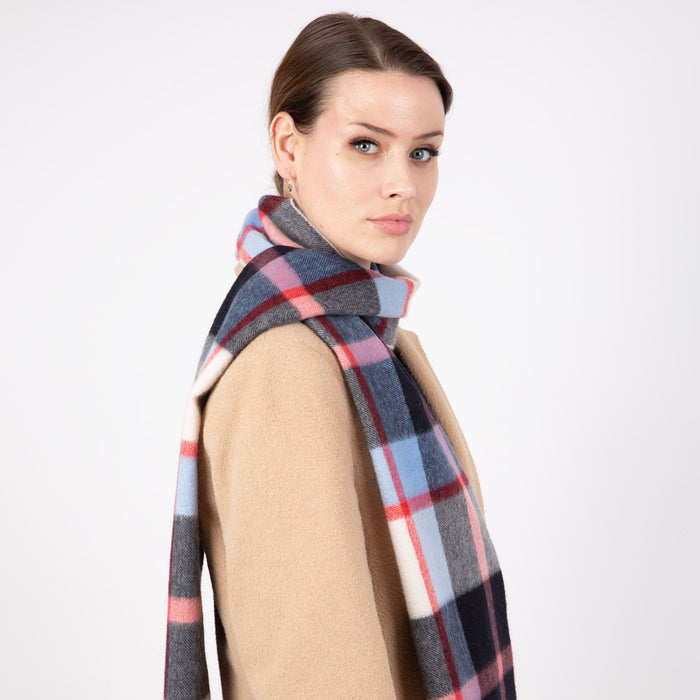 Woman wearing a Heritage plaid check cashmere scarf in frost