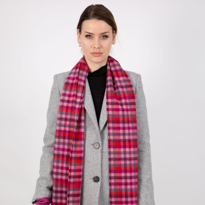Woman wearing a Heritage plaid check cashmere scarf in scarlet
