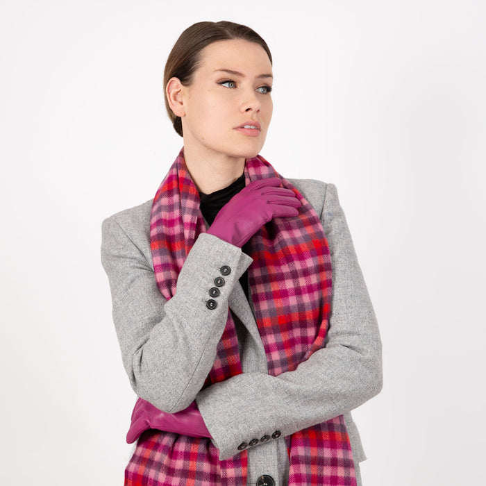 Woman wearing a Heritage plaid check cashmere scarf in scarlet