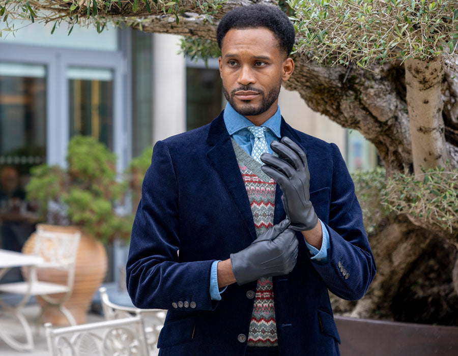 Man wearing leather driving gloves in navy outdoors