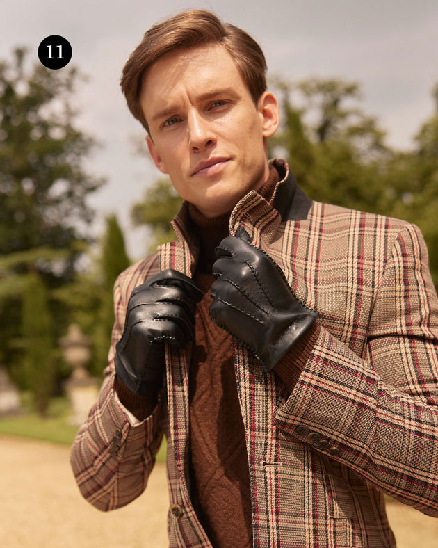 Man wearing leather cashmere-lined leather gloves in black at the park