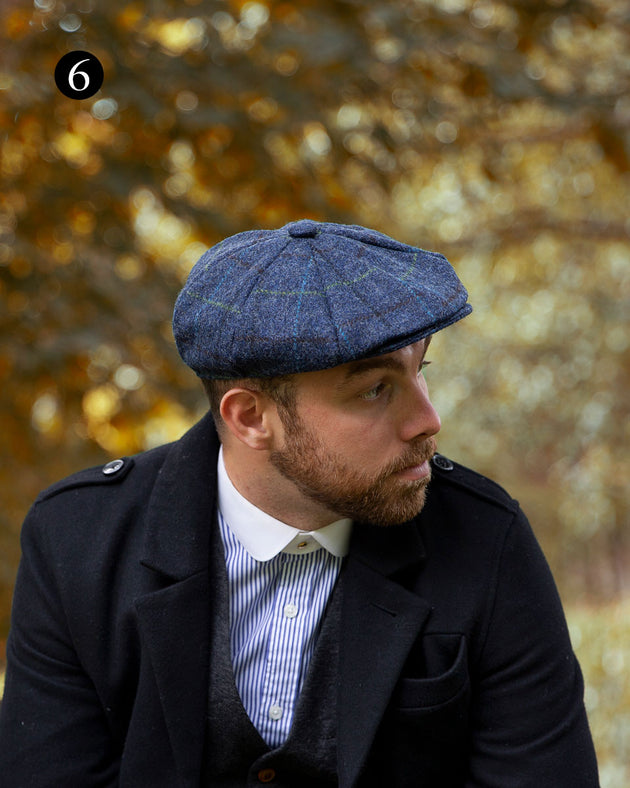 man wearing tweed check cap in blue in the woodlands