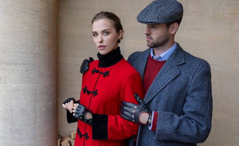 Man and woman wearing leather driving gloves in black outdoors