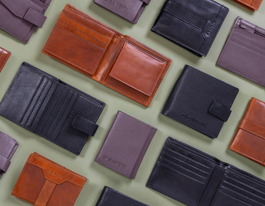 Men's leather wallets in various colours and styles on a green background