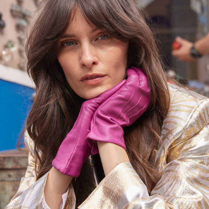 Woman wearing Women's Hot Pink Three Point Lined Leather Gloves in town