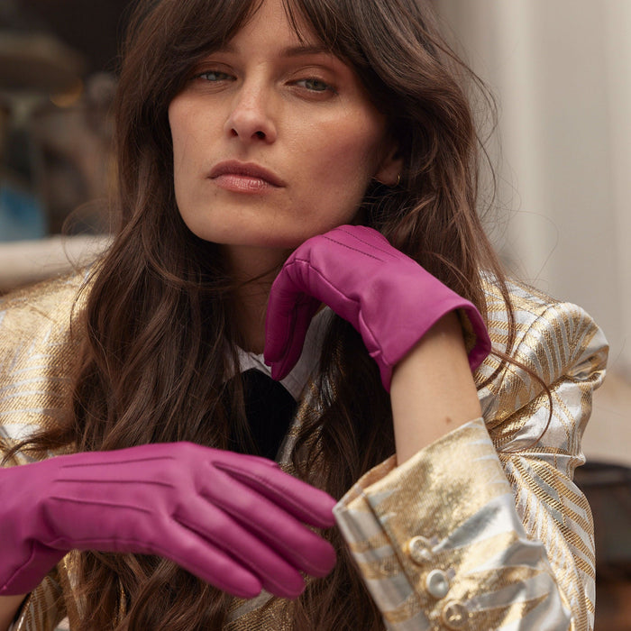 Woman wearing Women's Hot Pink Three Point Lined Leather Gloves in town