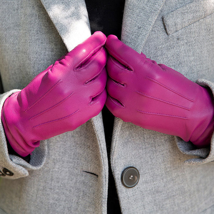 Woman wearing Women's Hot Pink Three Point Lined Leather Gloves in the park