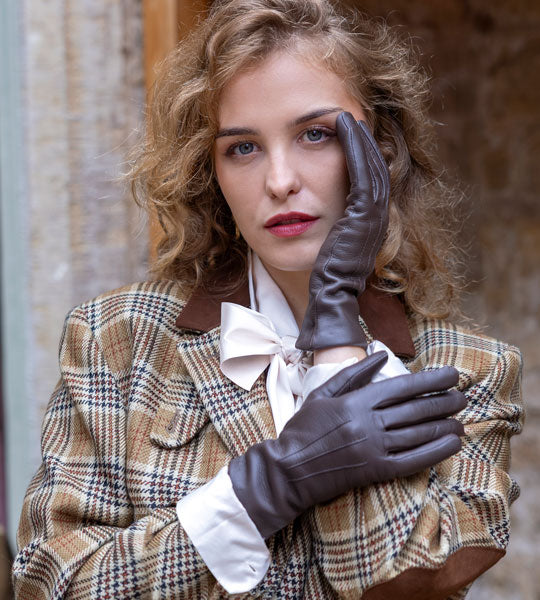 Woman wearing brown leather gloves outdoors