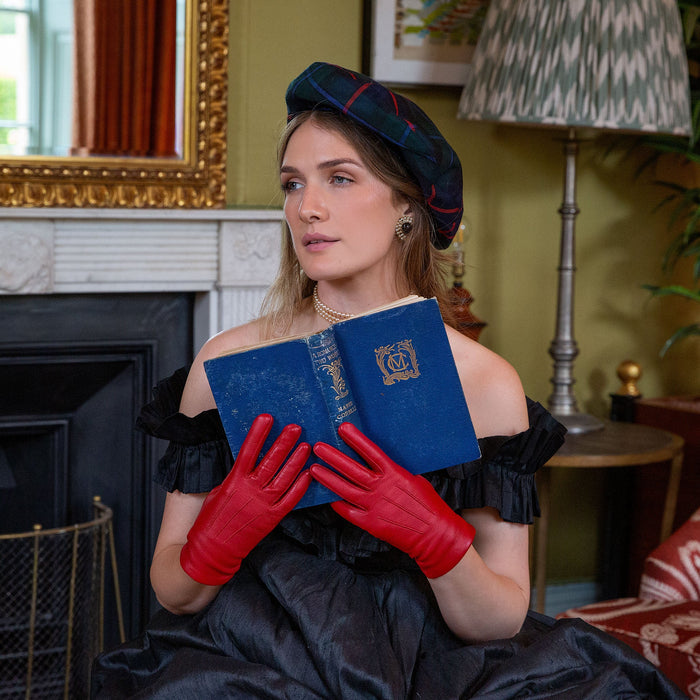 Woman wearing Women's Berry Three Point Lined Leather Gloves reading a book