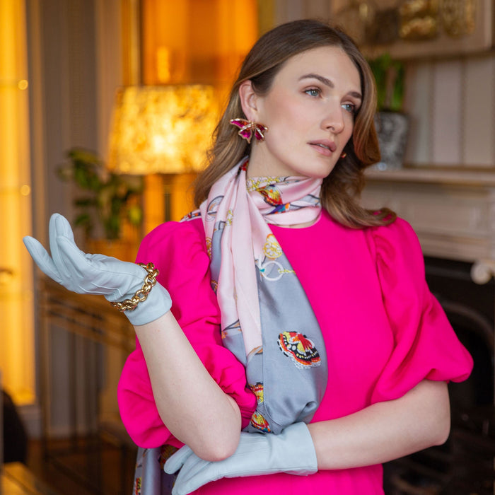 Woman wearing silk-lined leather gloves in silver 